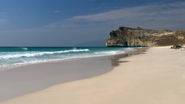 Sea waves striking sand beach near Salalah, Oman (Arabian Peninsula). 4K