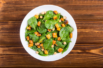 autumn salad with pumpkin , spinach , chickpea and sesame