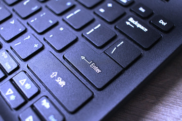 Enter button on laptop keyboard. Close up of Enter key of Laptop computer.  Enter keyboard key button on a computer with light effect. 