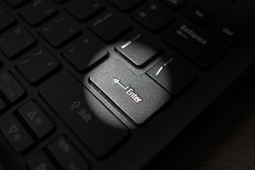 Enter button on laptop keyboard. Close up of Enter key of Laptop computer.  Enter keyboard key button on a computer with light effect. 