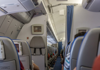 Interior of a commercial airplane with all passengers seated and ready for takeoff
