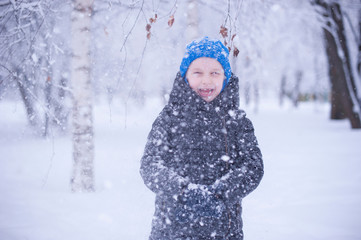 a child in a winter Park playing with snow