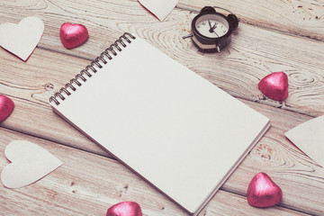 Valentine's day background. Empty blank notebook, gift box, flowers on a white background, top view. Free space for text