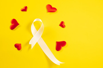 The white ribbon, a symbol of the international or world day of fight against lung cancer. The...