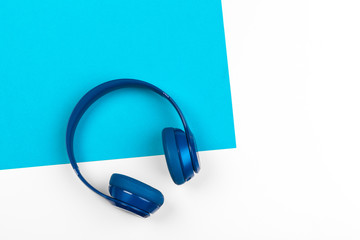 Blue headphones on blue and white color background