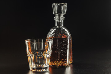 Glass of the whiskey and a square decanter