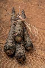 red carrots on wooden table with copy space