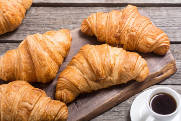 Croissants on wooden background