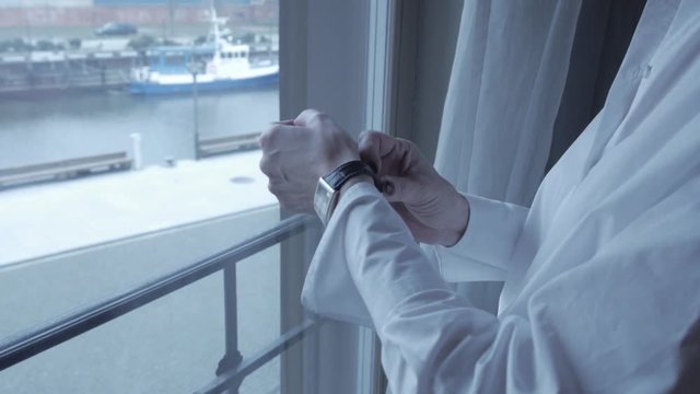 A woman is wearing a watch in the hotel.
