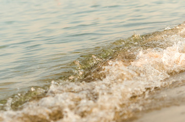 Seaside beach and soft blue sea wave.