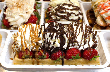 Belgian waffles with strowberry, caramel, chocolate and cream
