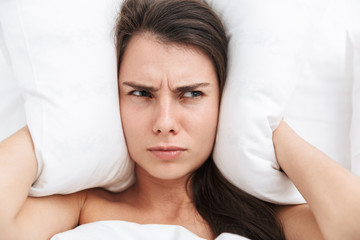 Top view close up of a beautiful young woman laying in bed