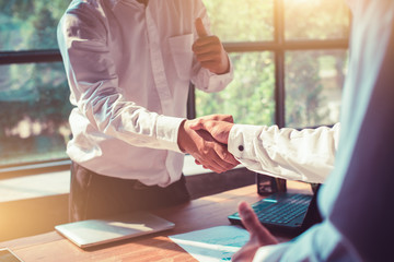 Businessmen shaking hands in the office.