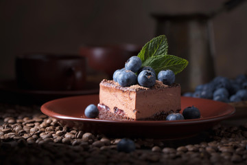 Chocolate cake with blueberries and mint .