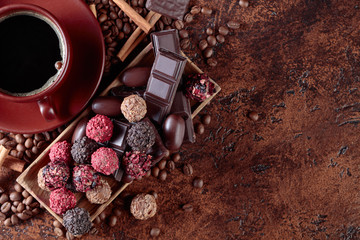 Various chocolates  and cup of black coffee.