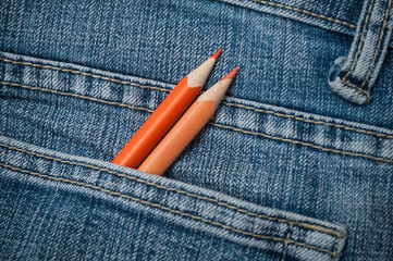 closeup of colouring pencils in blue jeans pocket