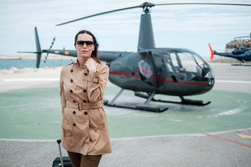Business woman near private a helicopter