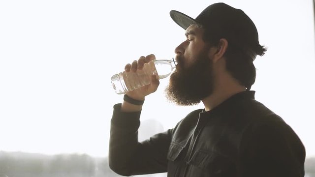 Bearded man drinking water 