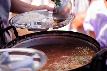 Philanthropists donate food to the poor, share food, help each other in society.