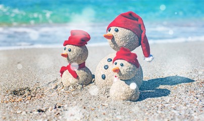 Sandy snowmen. Holiday concept can be used for New Year's and Christmas Cards