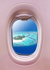 Airplane window view of Maldives island