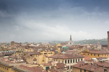 Fototapeta na wymiar Dramatic colorful aerial view of the beautiful city of Florence. Colorful rainy cityscape with dark blue clouds. Florence, Italy.
