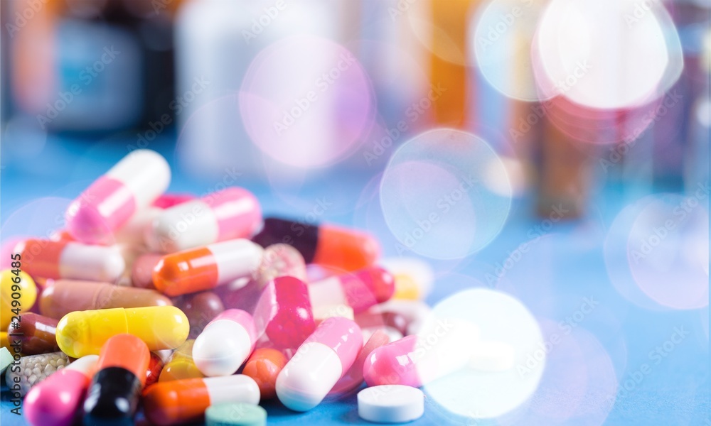 Poster Colorful pills and tablets on background