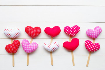 Valentine's hearts on white wooden background.