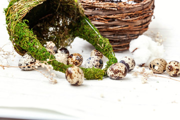 Easter decoration with eggs and basket on white wooden background. Easter egg hunt concept. Flat lay top view copy space. Spring greeting card