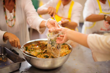 The hands of the hungry get food from the hands of volunteers : concept of hunger poverty
