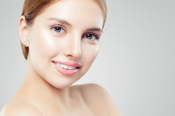 Obraz premium Beautiful young woman face, closeup portrait. Girl smiling