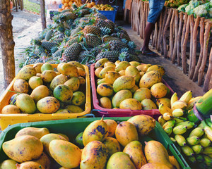 Fruit market in Sri Lanka. Fresh mango and pineapple on street market in Asia.