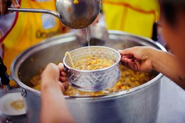 Hands holding food: Hunger problems are assisted by people in society.