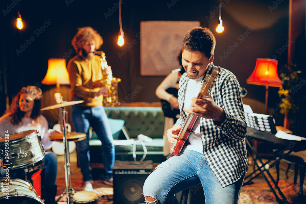 Poster Multicultural jazz band practicing for the gig in home studio.