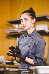 Subject profession and cooking pastry. young Caucasian woman with tattoo of pastry chef in kitchen...