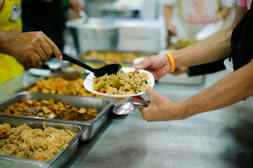 Providing food to the poor is helping people in a happy society.