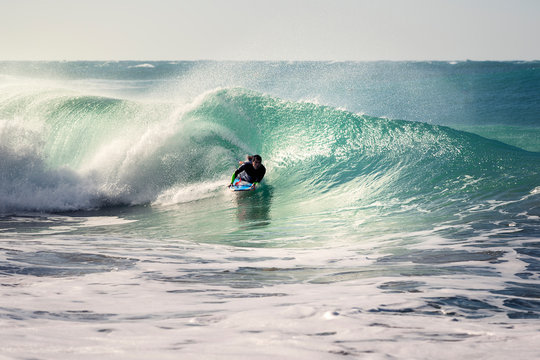man surfing a wave with his bodyboard