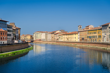 Fototapeta premium Old buildings of Pisa at Arno river shores. Toscana province, Italy
