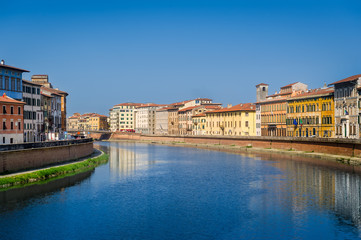 Fototapeta premium Calm waters of Arno river in the center of Pisa. Toscana province, Italy.