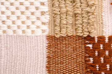 Horizontal fragment of tapestry with wool threads and stripes. Brown fabric texture. Colored background with close up of a traditional beautiful textile. Carpet texture.