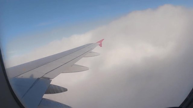 Airplane Interior View of Clouds Through Jet Window