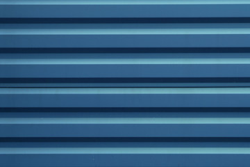 Blue corrugated metal panel texture. Copy space. Roofing material and building finishing.