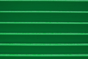 Horizontal corrugated wooden panel texture of green color. Place for your design. Copy space.