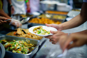 Volunteers donate food to help homeless and hungry people.