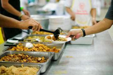 volunteers give food to local poor people, the villagers gladly accept the food as it may be the only food they get in a long while.