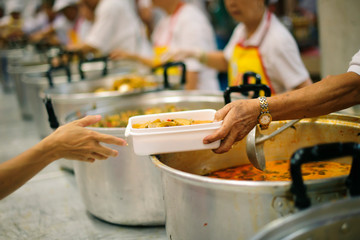 Volunteers have been feeding the homeless, They reach out with love and concern.