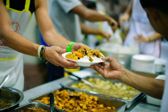 Volunteers have been feeding the homeless, They reach out with love and concern.