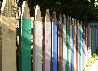 Multicolored wooden fence in the form of colored pencils.