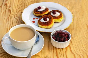 cup of coffee with cookies and milk on wooden background