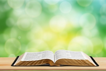 Open book on old wooden table